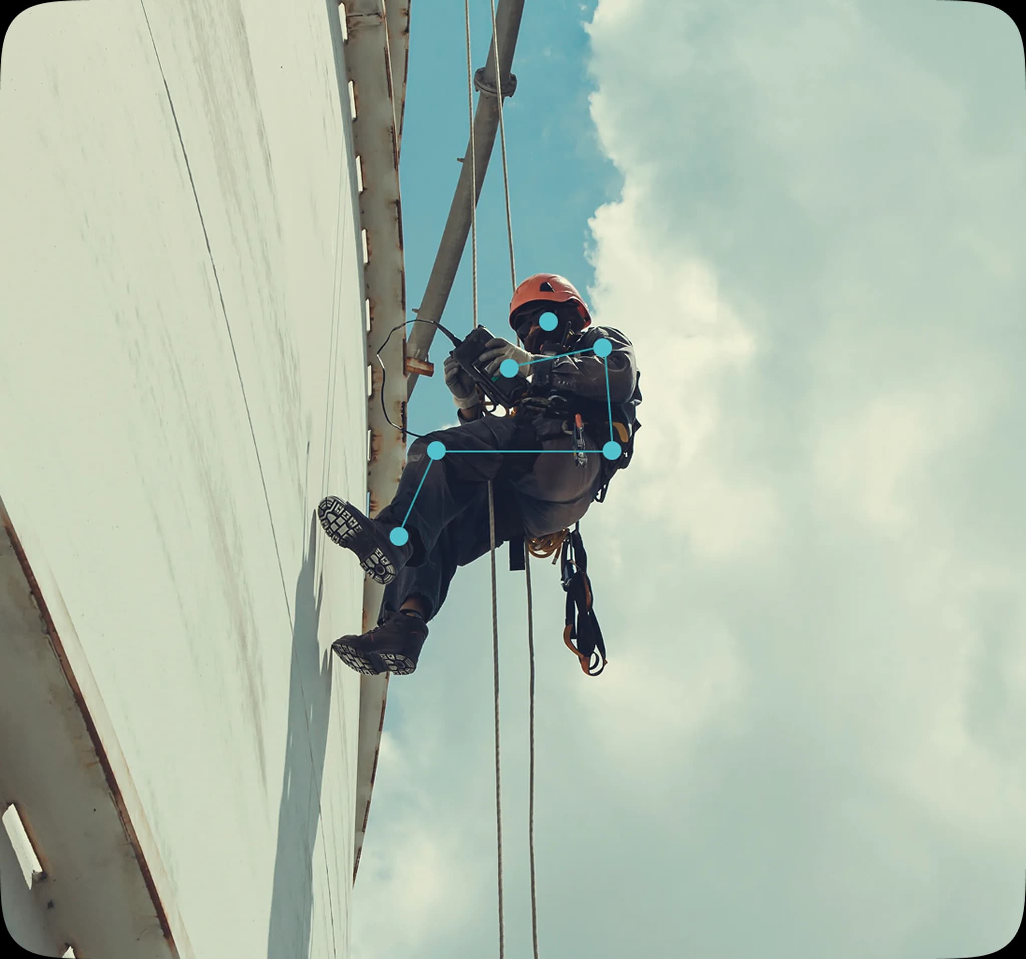 A rope access worker performing industrial maintenance at height